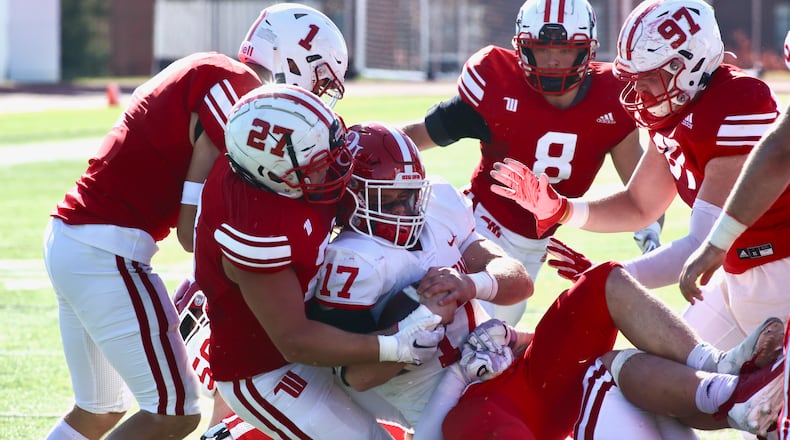 Wittenberg's Tony Calovini tackles Denison's Trey Fabrocini on Saturday, Oct. 22, 2022, at Edwards-Maurer Field in Springfield. David Jablonski/Staff