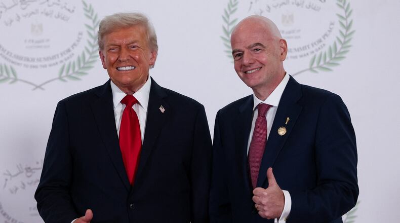 President Donald Trump and FIFA president Gianni Infantino pose for a photo in Sharm el-Sheikh, Egypt, Monday, Oct. 13, 2025. (Suzanne Plunkett, Pool Photo via AP)