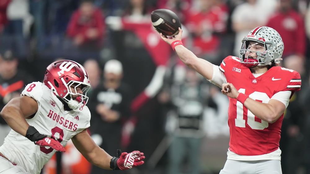 Ohio State's Julian Sayin throws with pressure from Indiana's Stephen Daley during the first half of the Big Ten championship NCAA college football game in Indianapolis, Saturday, Dec. 6, 2025. (AP Photo/AJ Mast)