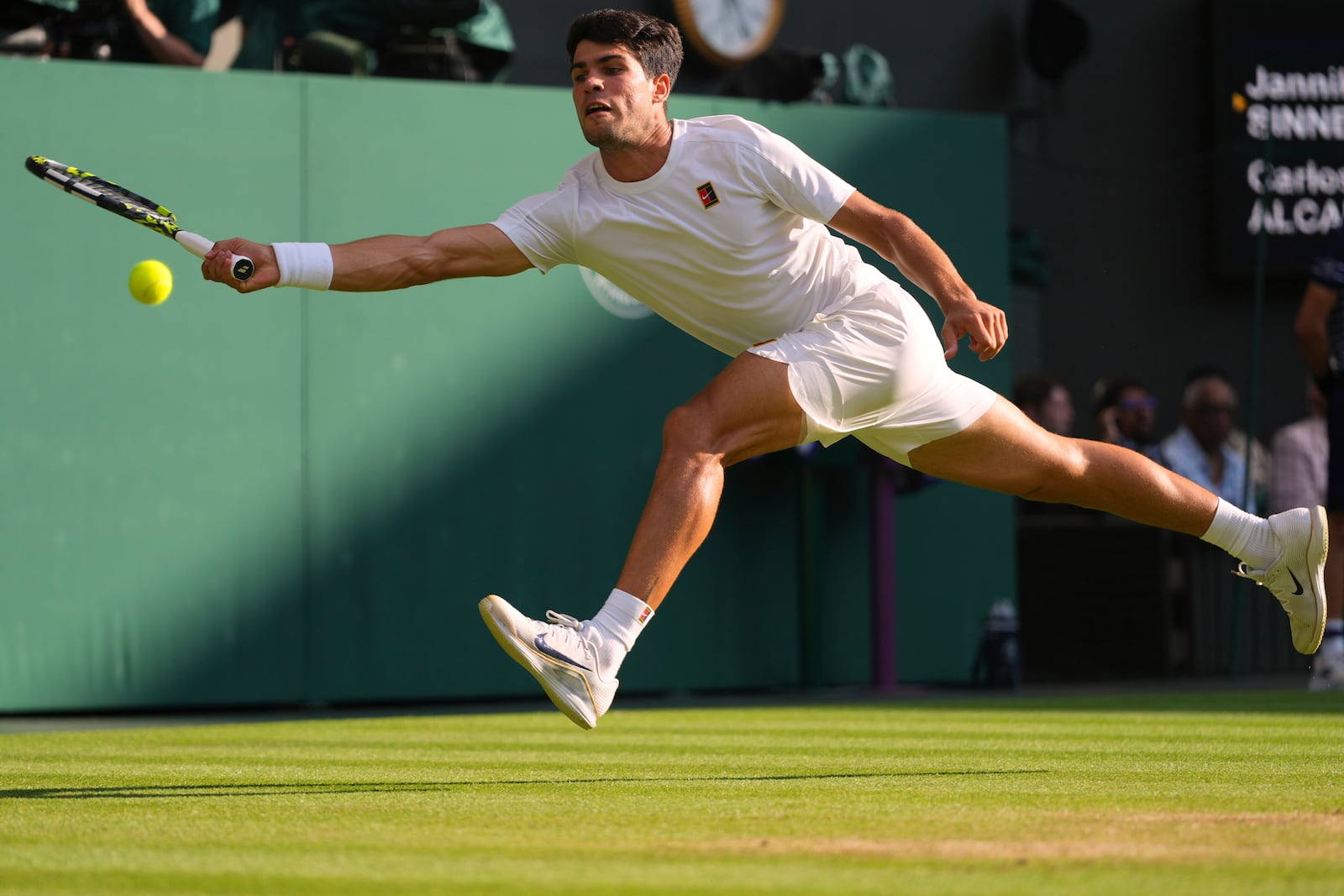 Carlos Alcaraz of Spain returns to Jannik Sinner of Italy during the men's singles final match at the Wimbledon Tennis Championships in London, Sunday, July 13, 2025.(AP Photo/Kirsty Wigglesworth)