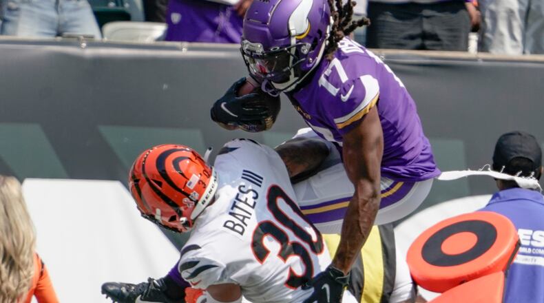 Minnesota Vikings wide receiver K.J. Osborn (17) tries to go over Cincinnati Bengals free safety Jessie Bates (30) as he runs after making a catch in the first half of an NFL football game, Sunday, Sept. 12, 2021, in Cincinnati. (AP Photo/Jeff Dean)