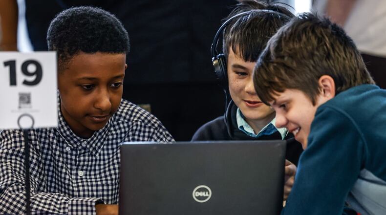 Dayton Stem School students from left, Noah Negassi, Jayden Clark and Liam Urbaniak play a game before the regional Flexfactor competition held at Sinclair College Friday April 19, 2024. The FlexFactor program is a collaborative technology and entrepreneurship program funded by the department of defense, that allows youth to discover the value of a career in advanced manufacturing. JIM NOELKER/STAFF