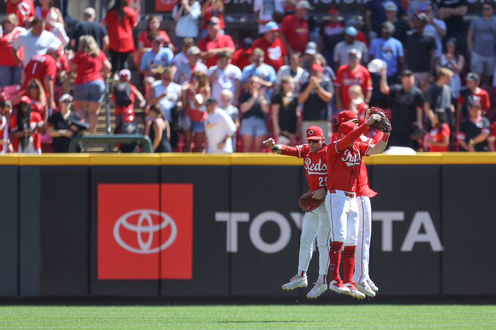 Cincinnati Reds' TJ Friedl, Austin Hays and Noelvi Marte celebrate after the team's win over the St. Louis Cardinals in a baseball game, Sunday, Aug. 31, 2025, in Cincinnati. (AP Photo/Abdoul Sow)