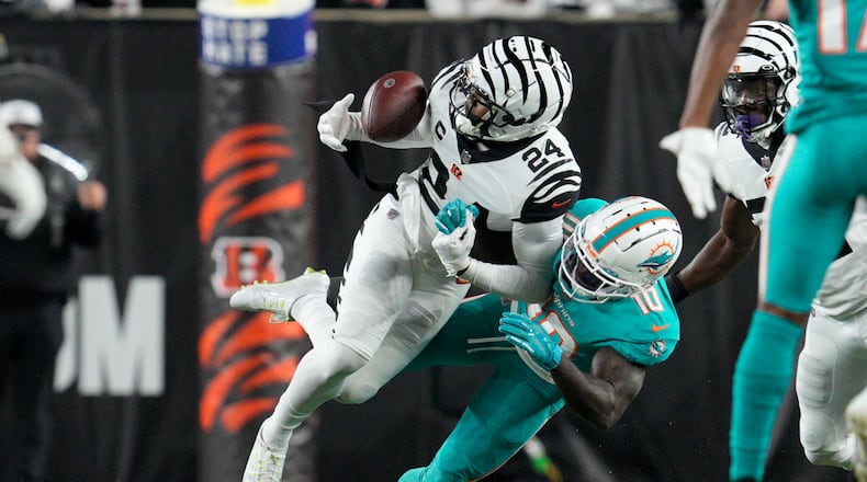 Cincinnati Bengals' Vonn Bell (24) makes an interception against Miami Dolphins' Tyreek Hill (10) during the first half of an NFL football game, Thursday, Sept. 29, 2022, in Cincinnati. (AP Photo/Jeff Dean)