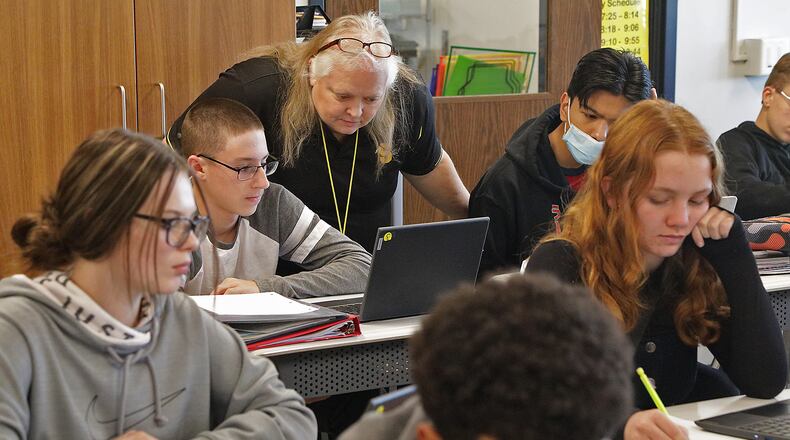 Brenda Vinson helps students in her financial literacy class a Shawnee High School. BILL LACKEY/STAFF