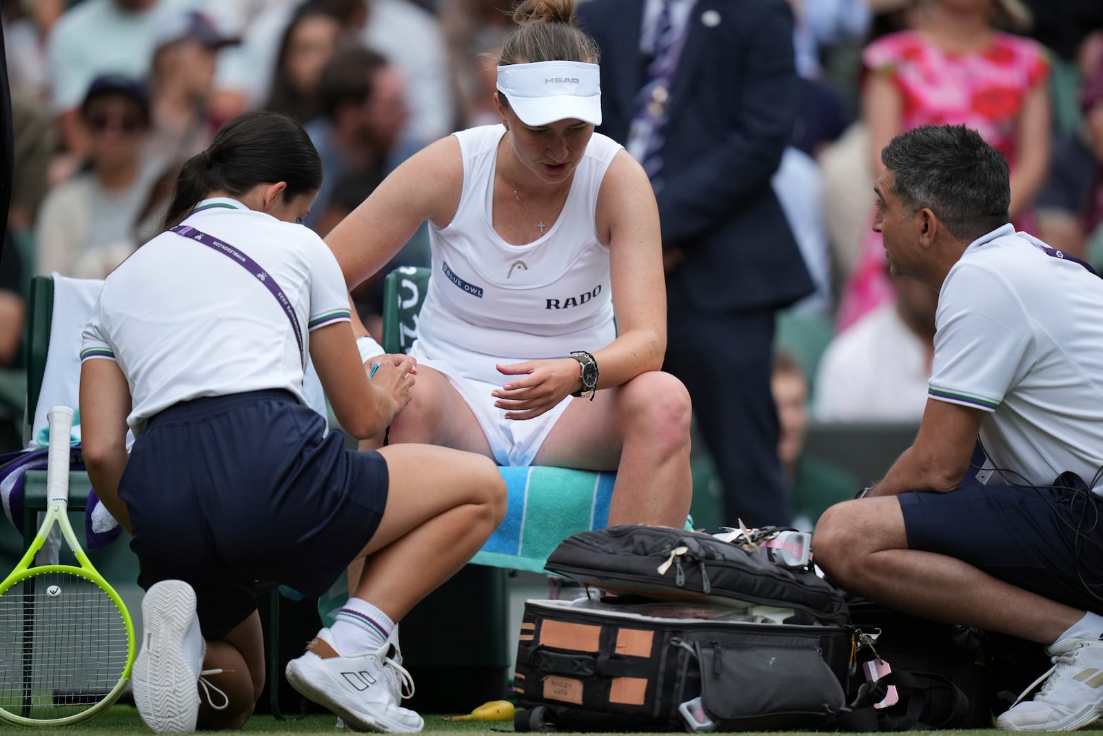 Barbora Krejcikova of Czech Republic gets assistance during her women's singles third round match against Emma Navarro of the U.S. at the Wimbledon Tennis Championships in London, Saturday, July 5, 2025.(AP Photo/Alastair Grant)