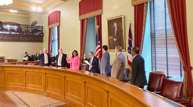 Members of the Ohio Redistricting Commission – from left, Senate President Matt Huffman, Auditor Keith Faber, House Minority Leader Emilia Sykes, Gov. Mike DeWine, Secretary of State Frank LaRose, House Speaker Bob Cupp and Sen. Vernon Sykes – take their oath at the Ohio Statehouse in Columbus, Ohio, during their first meeting on Aug. 6, 2021. (AP Photo/Julie Carr Smyth)