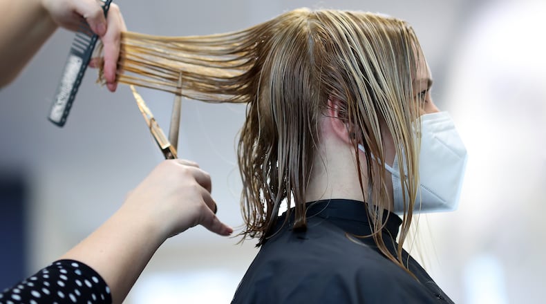 Deciding just how aggressively to fight aging -- the grays, the wrinkles -- is an age-old dilemma. (Ronny Hartmann via AP)