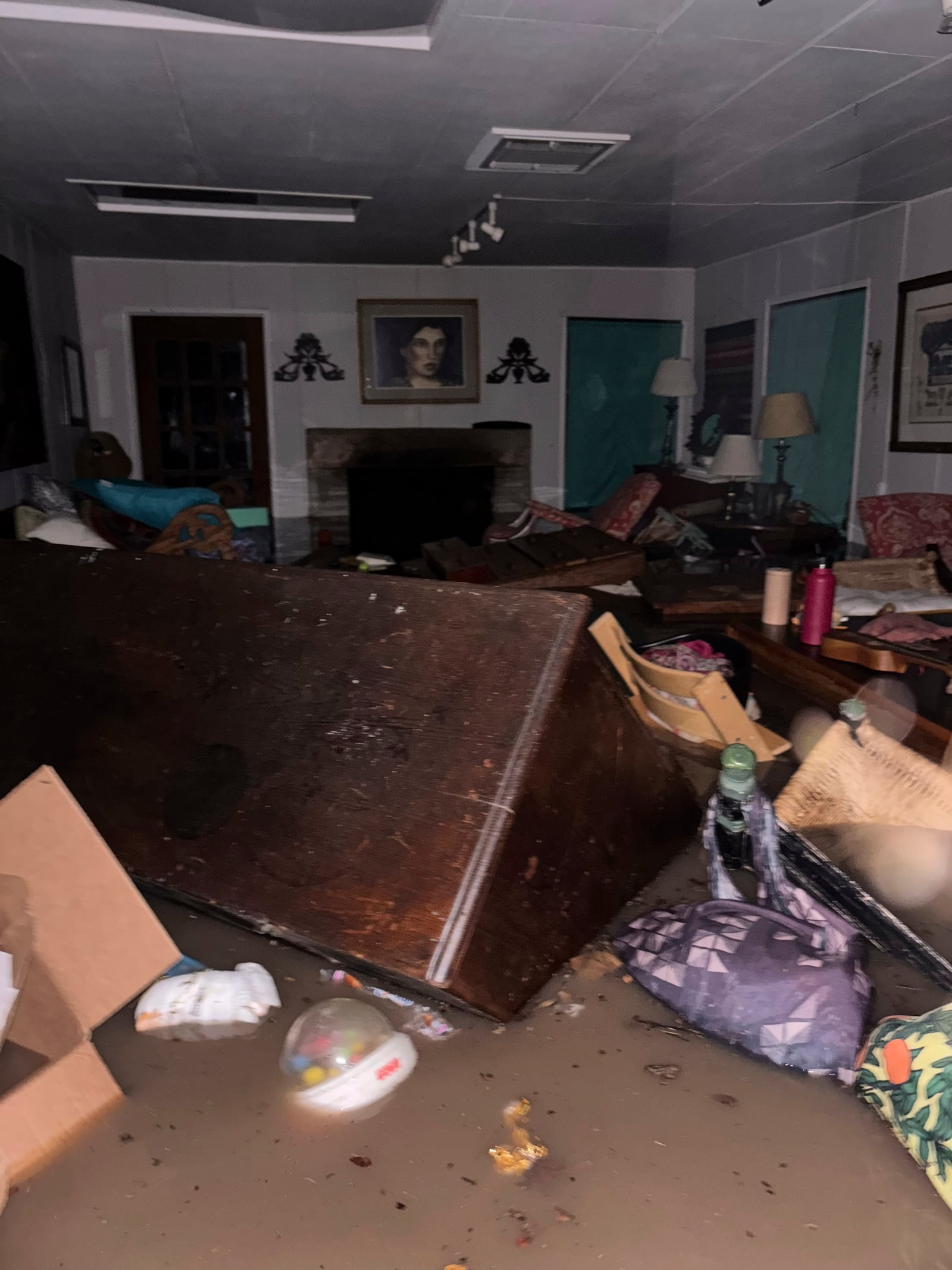Furniture and personal belongings float in floodwaters inside Alden Towler's cabin in Hunt, Texas, at 4:20 a.m. on Friday, July 4, 2025. (Shabd Simon-Alexander via AP)