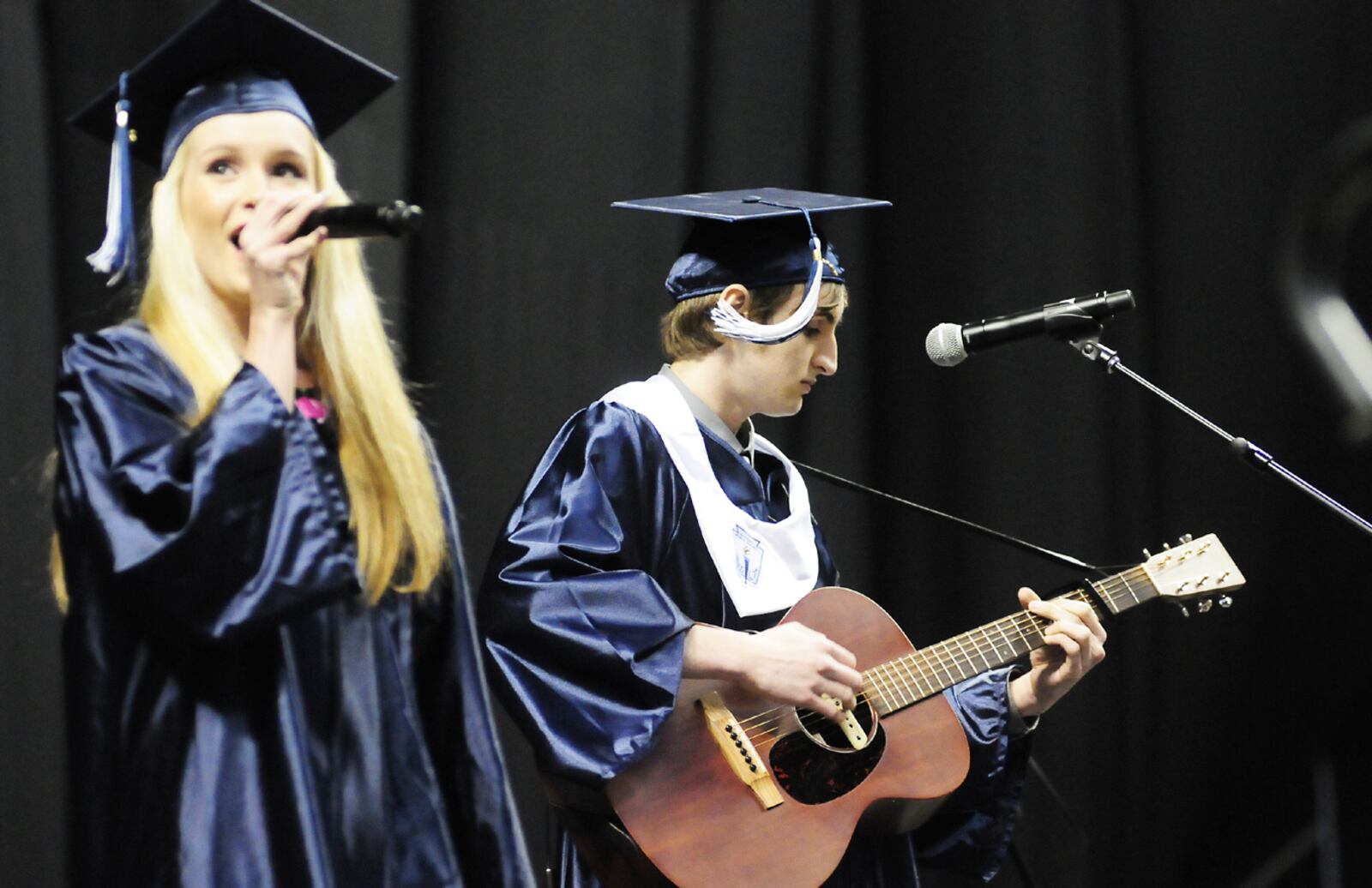 Holly Gyenes and Samuel Bodary play and sing " You're Gonna Make Me Lonesome When You Go" by Bob Dylan during Kettering Fairmont High School 2013 commencement ceremony held Wednesday evening May 22, 2013 at the Wright State University Nutter Center Photo by Charles Caperton