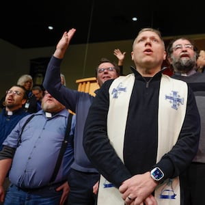 Faith leaders praise and sing along to Elevation Worship's "Trust in God" during Here We Stand: Faith Leaders for Immigration Justice & Family Unity at St. John Missionary Baptist Church on Monday, Feb. 2, 2026, in Springfield. Pastors and community members gathered to pray and call for the extension of Temporary Protected Status which is scheduled to expire on Tuesday, Feb. 3, 2026. JOSEPH COOKE/STAFF