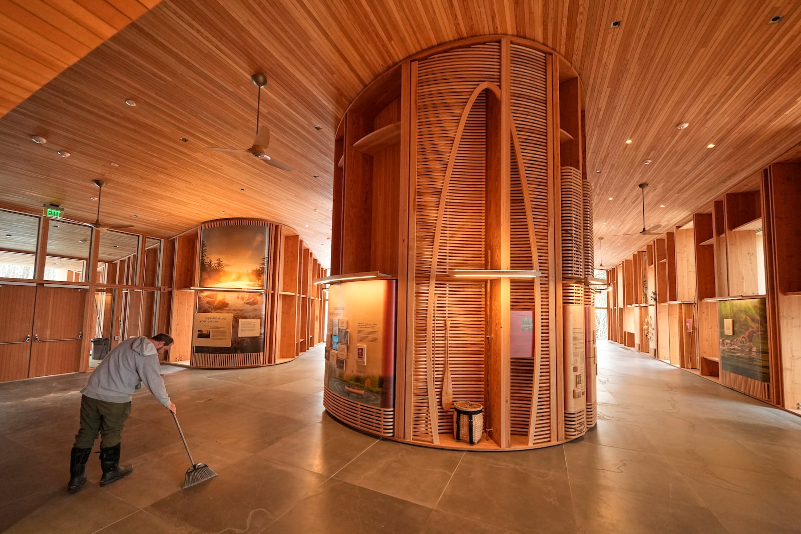 A national park employee sweeps the floor in the Tekakapimək Contact Station, Jan. 7, 2025, at the Katahdin Woods and Waters Monument in northern Maine. (AP Photo/Robert F. Bukaty)