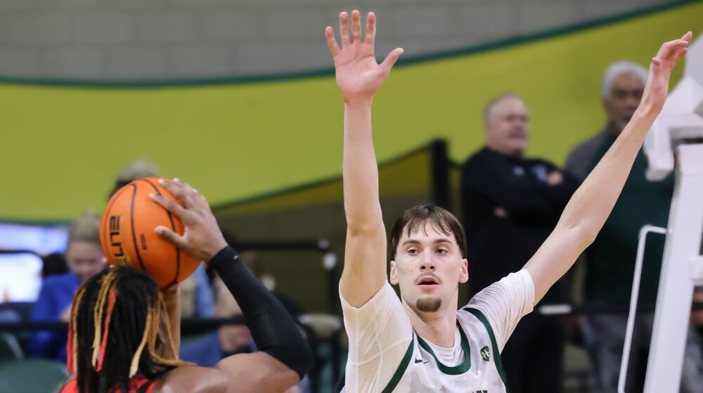 Wright State freshman forward Kellen Pickett tries to block a shot by Youngstown State's Bryson Dawkins during a Horizon League game on Thursday, Jan. 15 at Ervin J. Nutter Center in Fairborn. BRYANT BILLING/STAFF