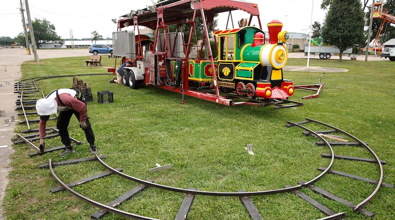 Workers from Durant Amusements unload the train ride on the midway at the Clark County Fairgrounds Tuesday, July 9, 2024. The Clark County Fair starts in 10 days. BILL LACKEY/STAFF