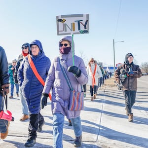 Maureen Dawn holds a "UNITY" sign during the Peace Walk for the National Day of Action hosted by Indivisible Springfield on Tuesday, Jan. 20, 2026, in Springfield. JOSEPH COOKE/STAFF