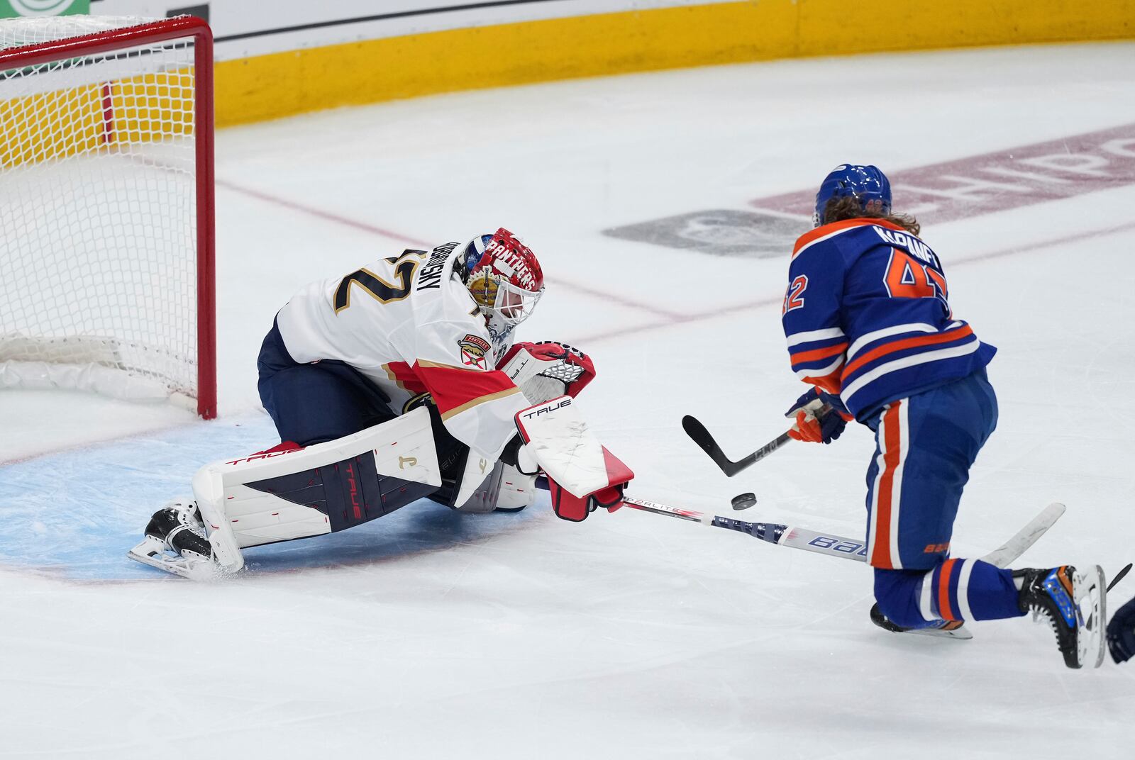 Edmonton Oilers' Kasperi Kapanen, right, puts a shot wide of the net as Florida Panthers goalie Sergei Bobrovsky poke-checks him during the first overtime period in Game 1 of the NHL Stanley Cup Final, in Edmonton, Alberta, on Wednesday, June 4, 2025. (Darryl Dyck/The Canadian Press via AP)