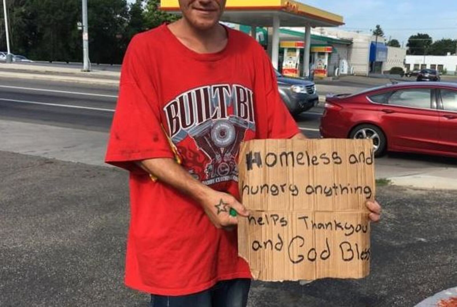 A Dayton panhandler shows his sign. CORNELIUS FROLIK / STAFF