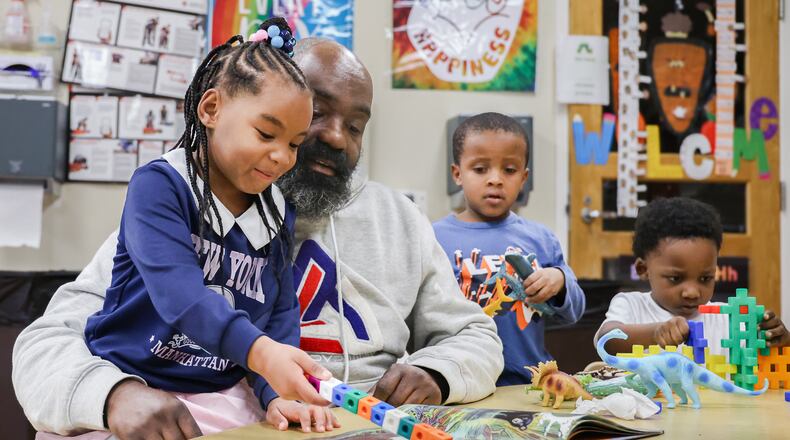 Jovan Etter reads to children in his classroom at Miami Valley Child Development Center in Trotwood on Tuesday. A program that provides child care and early childhood education could see its funding eliminated if a Trump administration budget proposal moves forward. BRYANT BILLING / STAFF