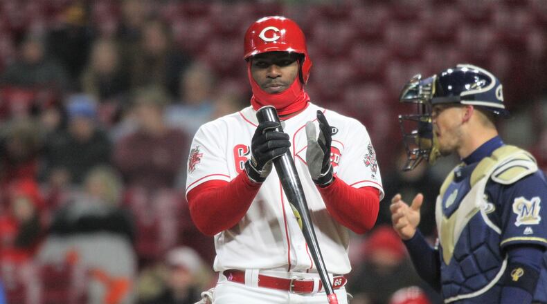 The Reds' Yasiel Puig bats in the ninth inning against the Brewers on Monday, April 1, 2019, at Great American Ball Park in Cincinnati.