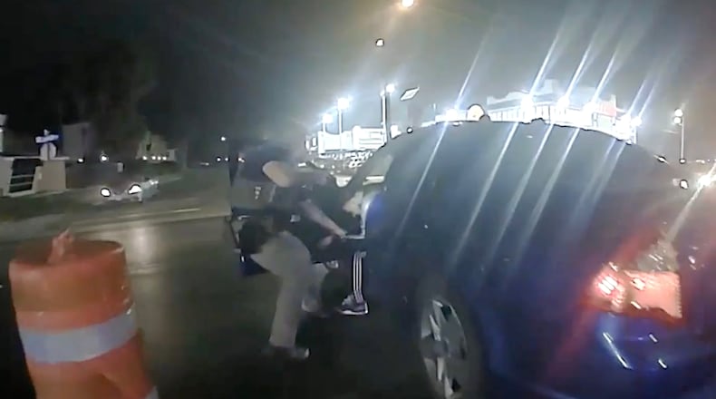 In this image from video provided by the Texas Department of Public Safety, Homeland Security Investigations Special Agent Jack Stevens pulls Ruben Ray Martinez from his vehicle after shooting Martinez at a roadblock in South Padre Island, Texas, on March 15, 2025. (Officer Miguel Leal/Texas Department of Public Safety via AP)
