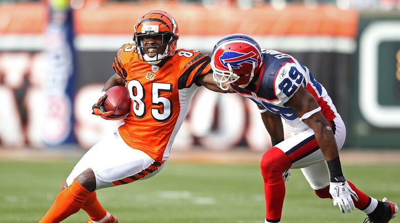 Former Bengals wide receiver Chad Johnson tries to get past Buffalo defender Drayton Florence in a 2010 game in Paul Brown Stadium. Johnson is one of 13 former players who are candidates for this year's Ring of Honor. Dayton Daily News file photo