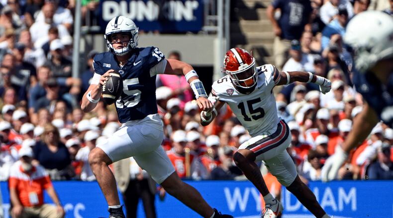 Penn State quarterback Drew Allar (15) runs away from Bowling Green linebacker Avi McGary (15) during the third quarter of an NCAA college football game, Saturday, Sept. 7, 2024, in State College, Pa. (AP Photo/Barry Reeger)