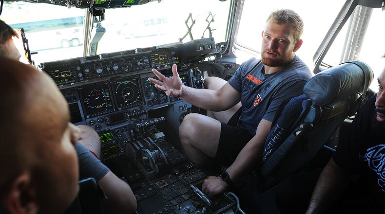 Cincinnati Bengals fourth-round draft pick Cordell Volson sits in the pilot seat of a C-17 aircraft at the 445th Airlift Wing at Wright-Patterson Air Force Base Friday on June 3, 2022. MARSHALL GORBY\STAFF