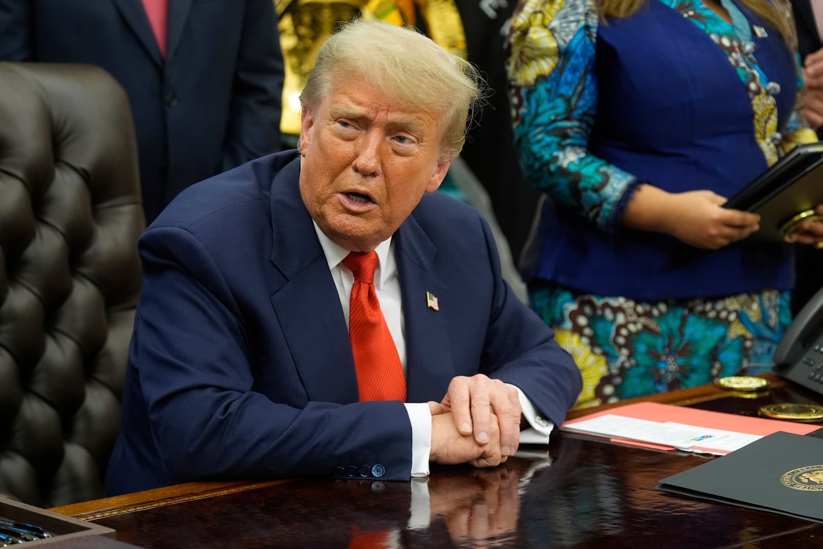 President Donald Trump answers questions from reporters as he meets with Congo's Foreign Minister Therese Kayikwamba Wagner, and Rwanda's Foreign Minister Olivier Nduhungirehe, Friday, June 27, 2025, in the Oval Office at the White House in Washington. (AP Photo/Manuel Balce Ceneta)