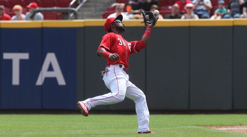 Reds second baseman Arismendy Alcantara drops a pop fly against the Brewers on Sunday, April 16, 2017, at Great American Ball Park in Cincinnati. David Jablonski/Staff