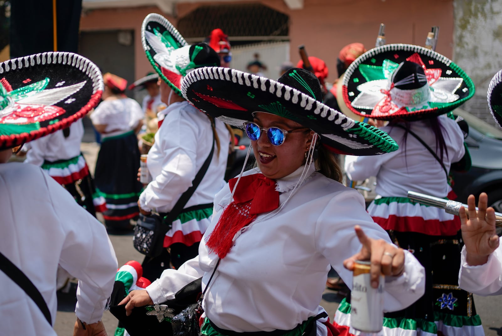 FILE - Women dance during a re-enactment of The Battle of Puebla as part of Cinco de Mayo celebrations in the Peñon de los Baños neighborhood of Mexico City, May 5, 2022. (AP Photo/Eduardo Verdugo, File)