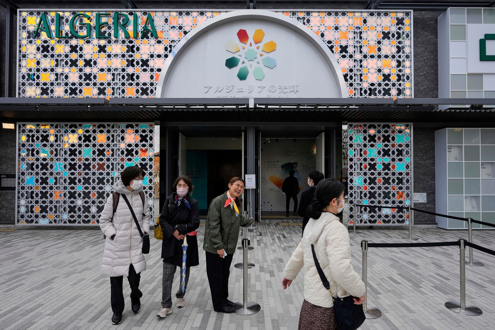 A staff member at Algeria's pavilion greets visitors during the Expo 2025 in Osaka, western Japan, Tuesday, April 15, 2025. (AP Photo/Hiro Komae)