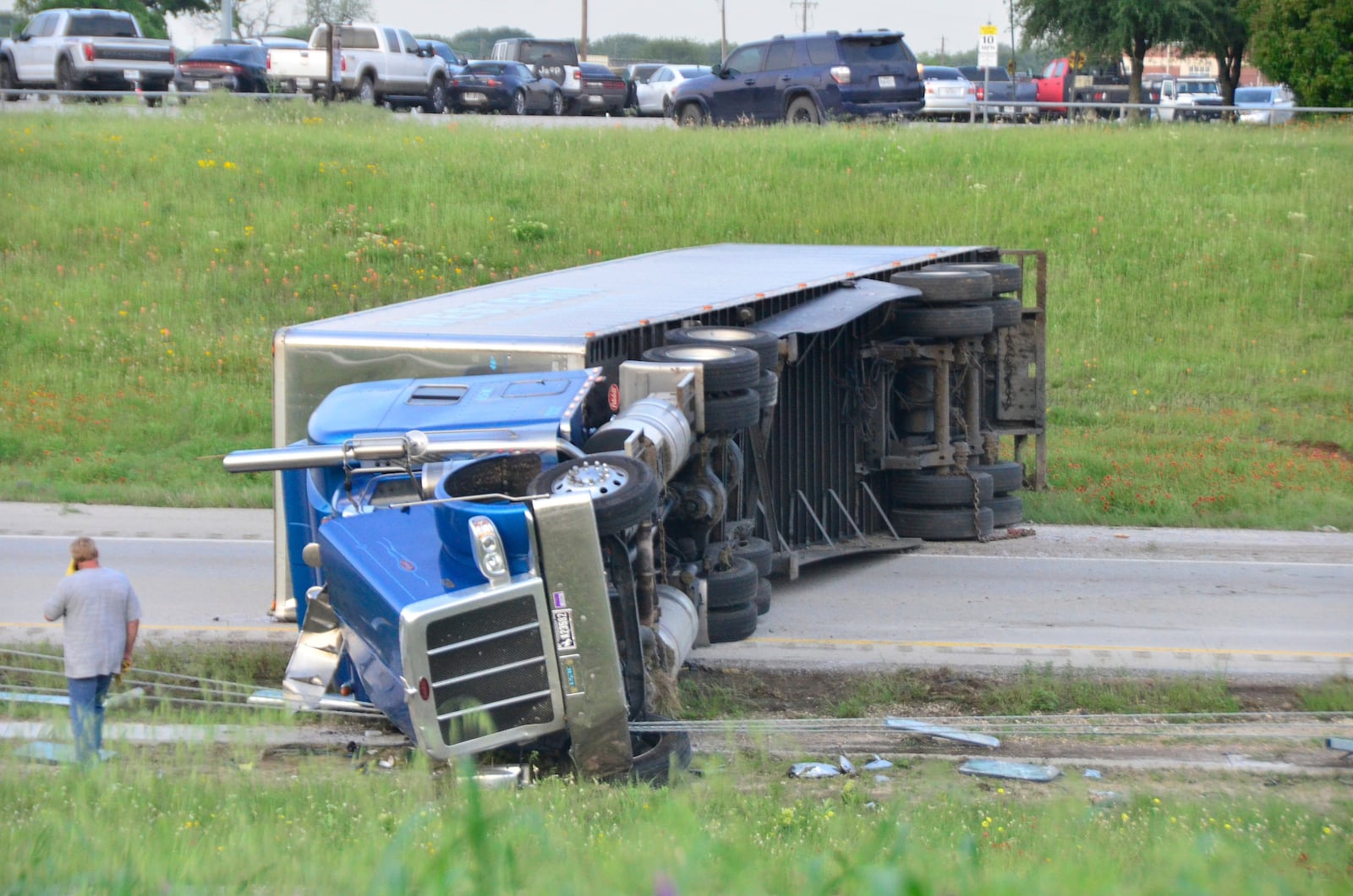 This image provided by the Wise County Messenger shows an 18-wheeler that was hauling dimes after rolling over on U.S. 81/287 near Alvord High School, Tuesday, April 29, 2025 in Alvord, Texas. (Austin Jackson/Wise County Messenger via AP)