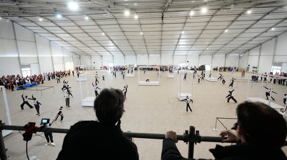 Volunteer dancers perform during rehearsals for the opening ceremony of the Milan Cortina 2026 Winter Olympic Games, at a compound in a big tent next to San Siro Stadium, in Milan, Italy, Saturday, Jan. 24, 2026. (AP Photo/Luca Bruno)