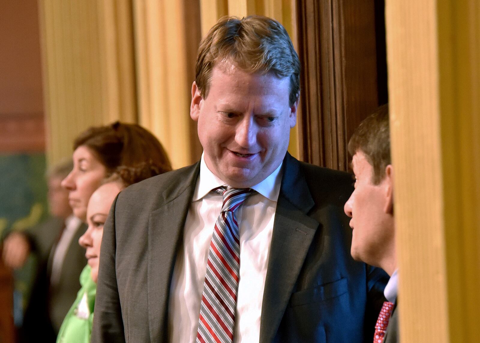 FILE - Rep. Tim Greimel, D-Auburn Hills talks with other legislators as the Michigan House of Representatives debates, July 12, 2017, in the Capitol in Lansing, Mich. (Dale G Young/Detroit News via AP, File)/Detroit News via AP)