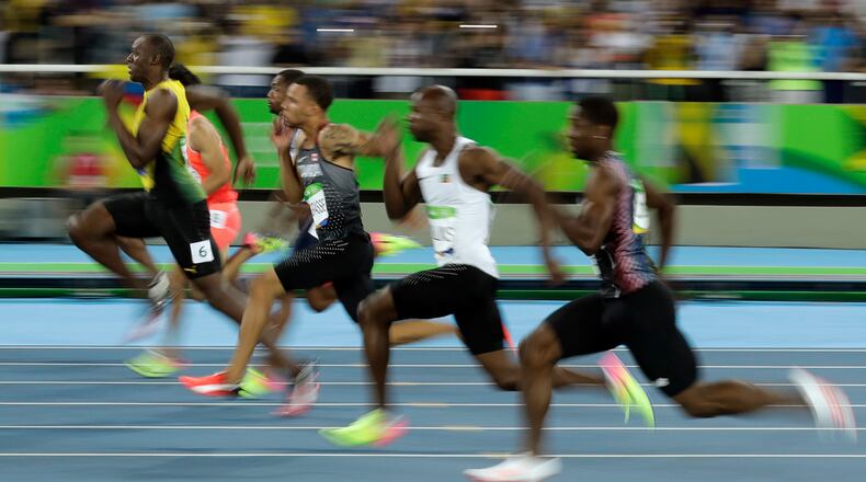 Jamaica's Usain Bolt, left, takes the lead in a men's 100-meter semifinal during the athletics competitions of the 2016 Summer Olympics at the Olympic stadium in Rio de Janeiro, Brazil, Sunday, Aug. 14, 2016. (AP Photo/Matt Dunham)