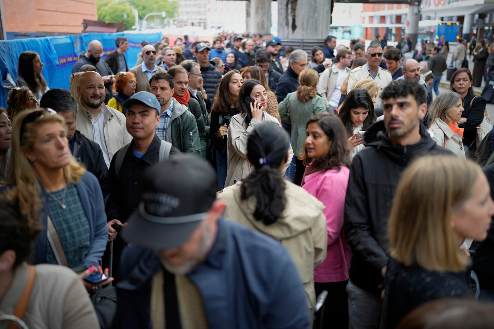Travelers wait for news about their delayed trains at the Madrid train station, Spain, Monday, May 5, 2025. (AP Photo/Manu Fernandez)