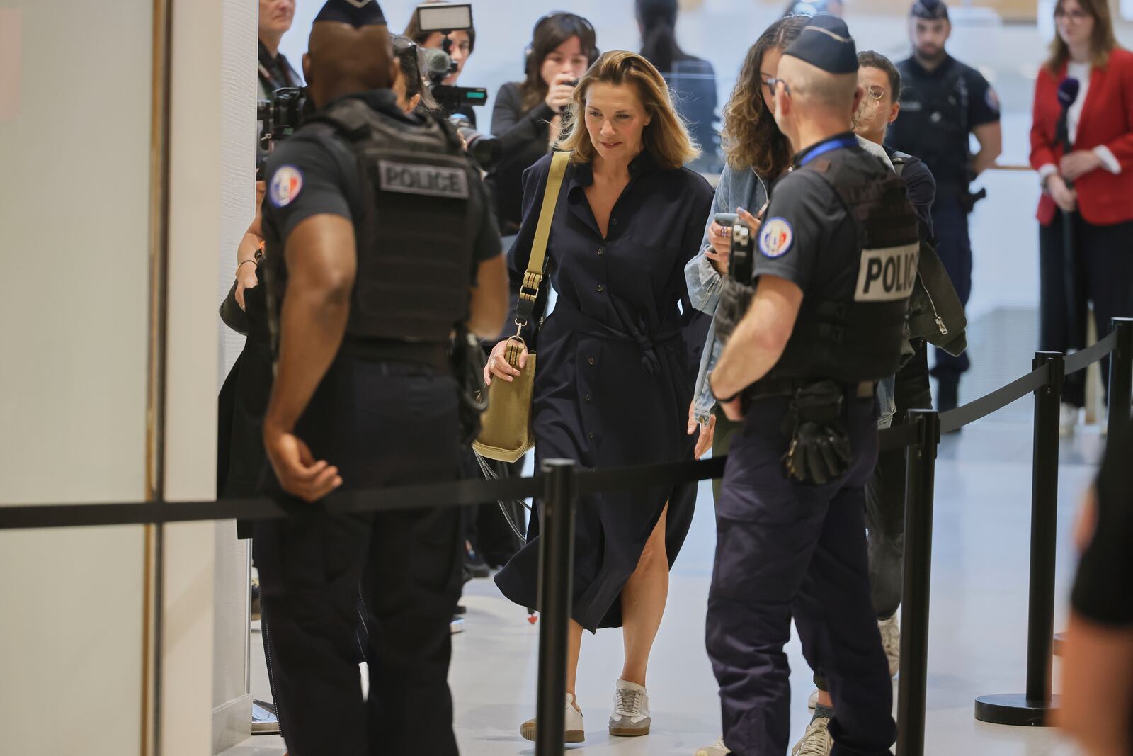 A plaintiff arrives in a Paris court, which is set to deliver a verdict on accusations that French actor Gerard Depardieu sexually assaulted two women who were working on a film with him in 2021, in Paris, Tuesday, May 13, 2025. (AP Photo/Thomas Padilla)