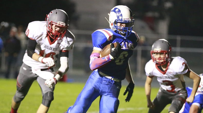 Greeneview’s Nick Clevenger runs between Southeastern’s Hayden Toops, left, and Lane McCombs on his way to a touchdown last season. In Greeneview’s 31-0 win last week against Arcanum last week, the first-year quarterback completed 5-of-7 passes for 119 yards and a touchdown. The junior, also ran for a team-high 93 yards and a touchdown on 14 carries. BILL LACKER / STAFF