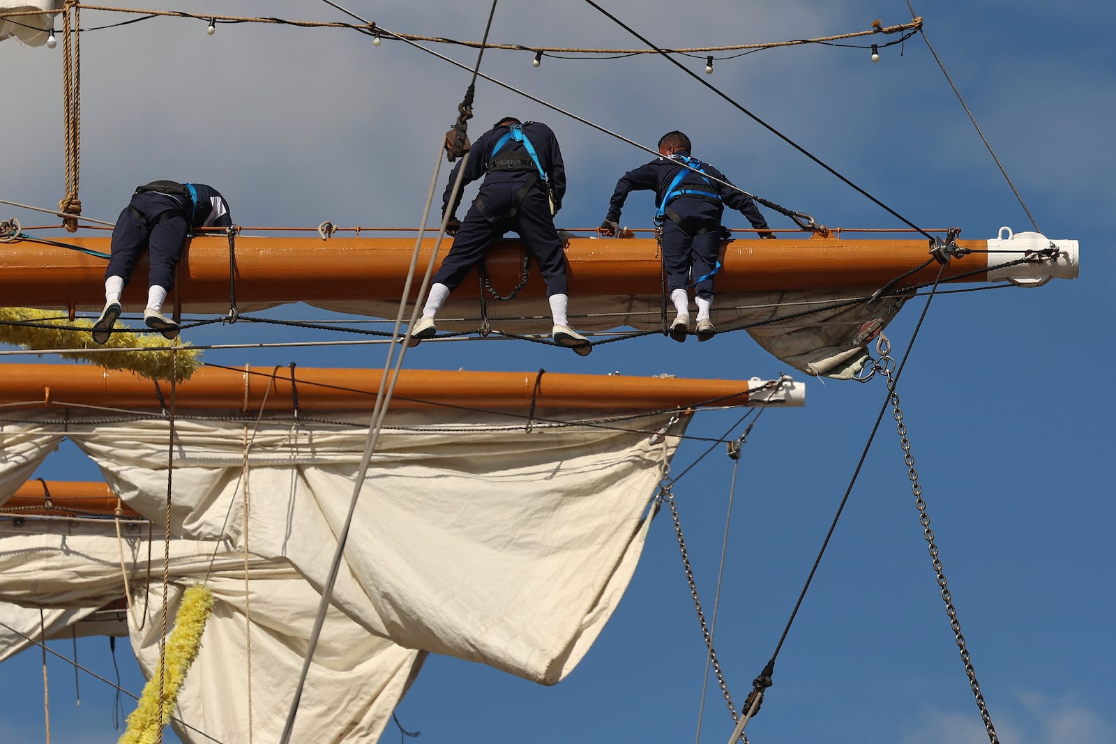 Sailors work on the yard arms of the Cuauhtémoc, Sunday, May 18, 2025 in New York. The masted Mexican Navy training ship collided with the Brooklyn Bridge the night before. (AP Photo/Yuki Iwamura)