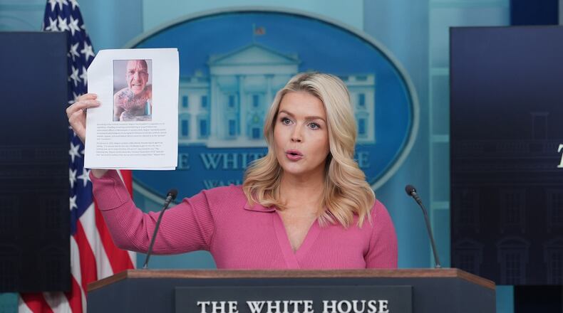 White House press secretary Karoline Leavitt holds a photo of Kyle Wagner, as she speaks during a briefing at the White House, Thursday, Feb. 5, 2026, in Washington. (AP Photo/Evan Vucci)