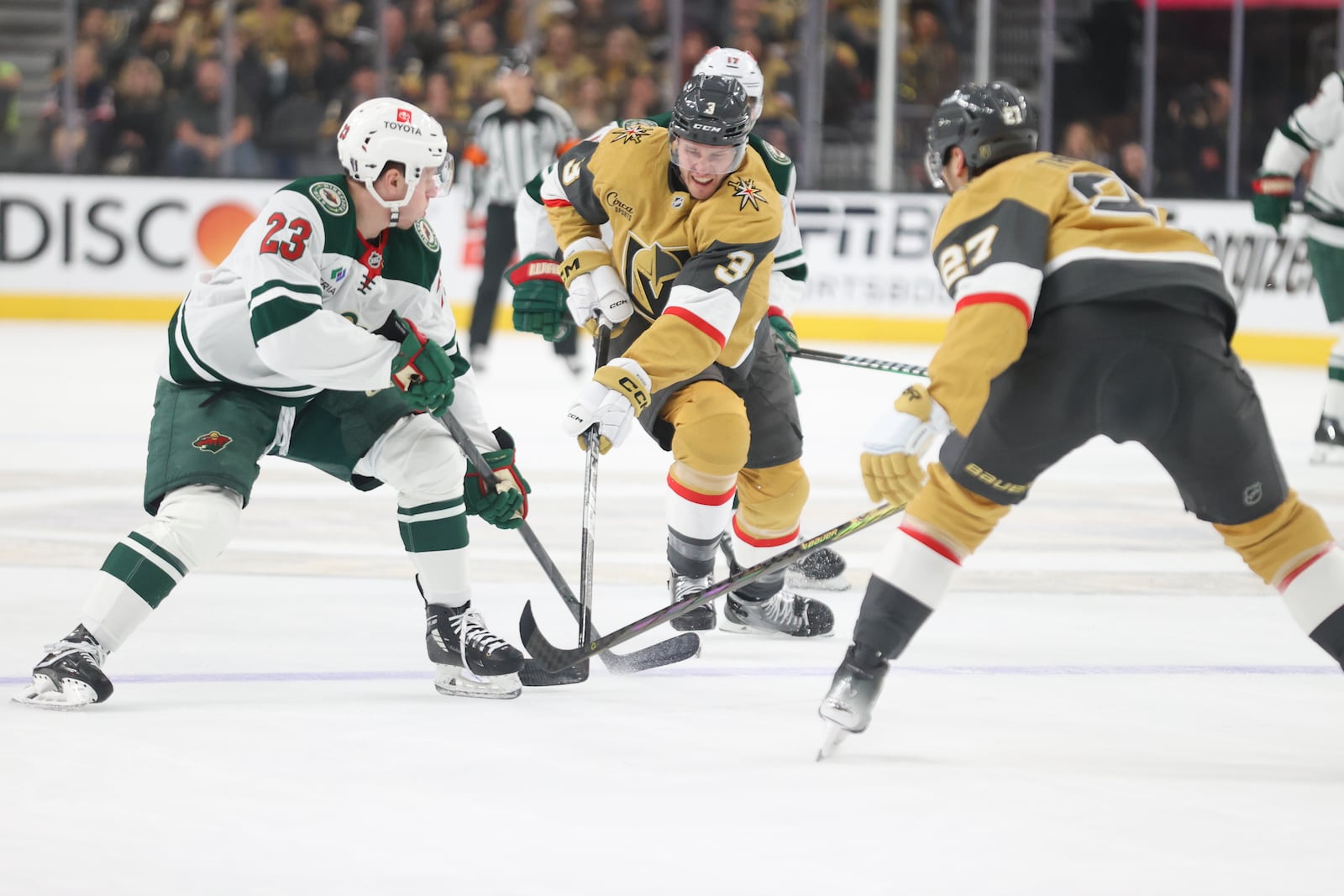 Vegas Golden Knights defenseman Brayden McNabb (3) skates past Minnesota Wild center Marco Rossi (23) during the first period in Game 1 of an NHL hockey Stanley Cup first-round playoff series Sunday, April 20, 2025, in Las Vegas. (AP Photo/Ian Maule)