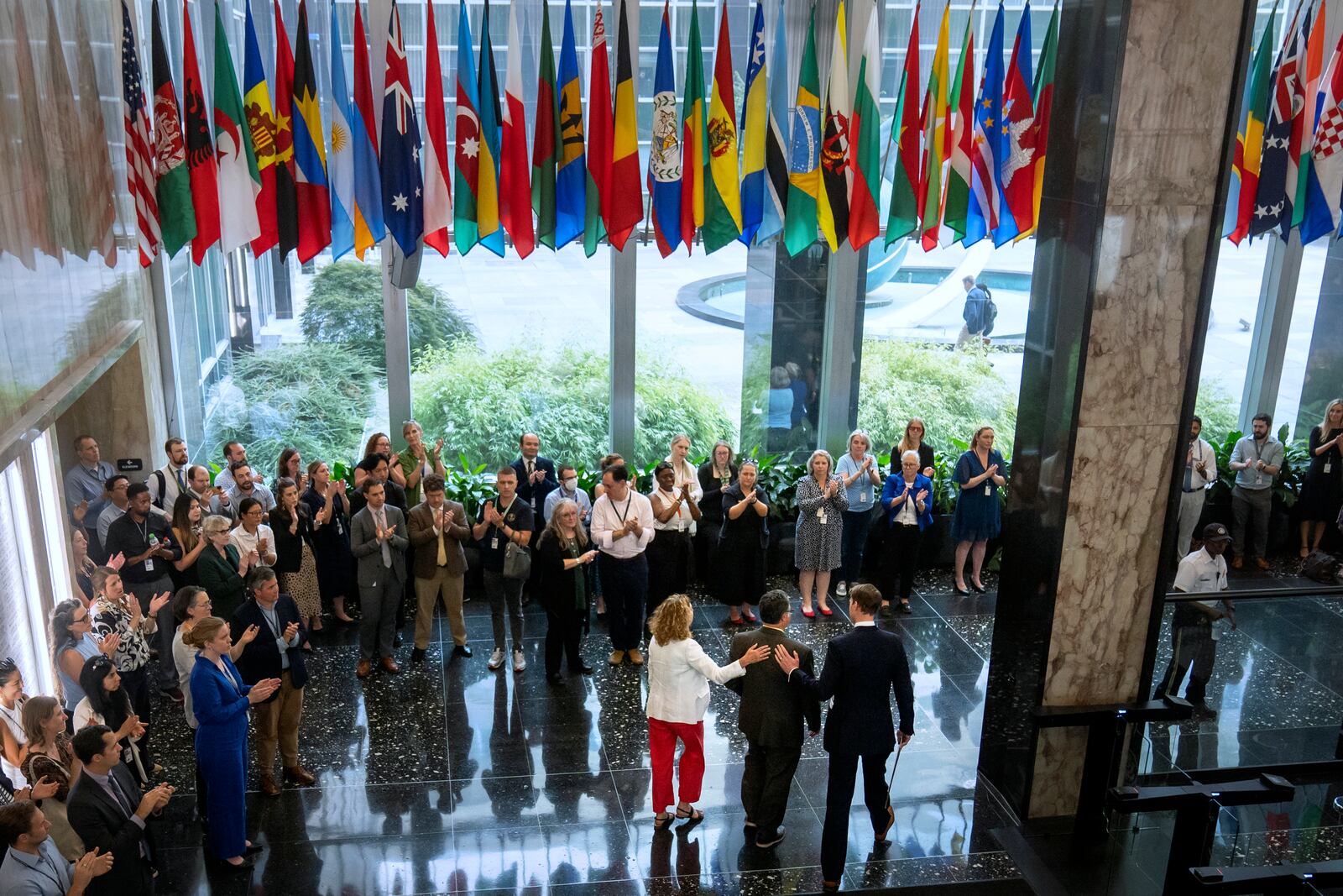 State Department employees applaud as their colleagues walk through the lobby of the State Department headquarters in the Harry S. Truman Building, Friday, July 11, 2025, in Washington. (AP Photo/Mark Schiefelbein).