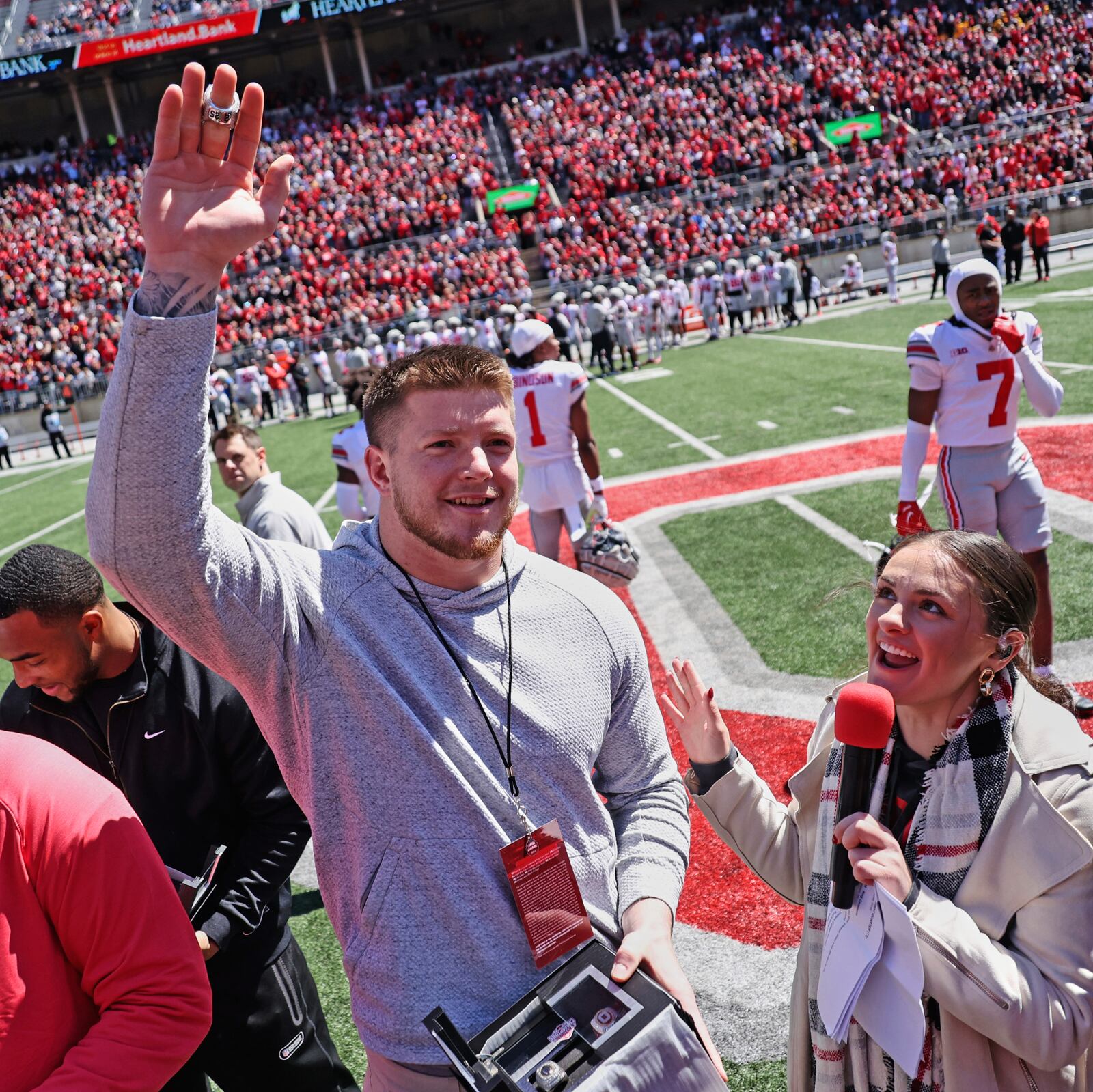 Ohio State's Jack Sawyer acknowledges the crowd after opening his box containing his NCAA college football championship rings during the school's spring football game, Saturday, April 12,2 025, in Columbus, Ohio. (David Petkiewicz/Cleveland.com via AP)