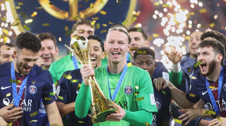 PSG's goalkeeper Matvey Safonov holds the trophy after winning the FIFA Intercontinental Cup final soccer match between Flamengo and Paris Saint-Germain in Doha, Qatar, Wednesday, Dec. 17, 2025. (AP Photo/Hussein Sayed)