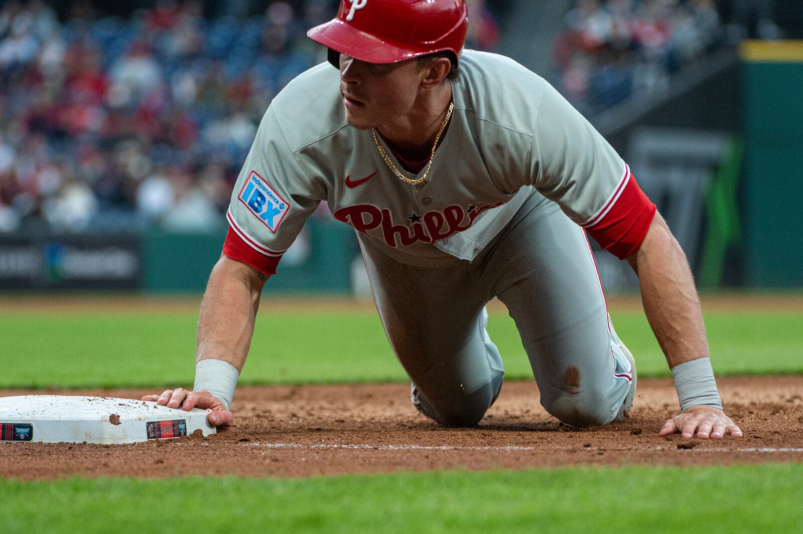 Philadelphia Phillies' Max Kepler gets back to first base safely on a pick off attempt by Cleveland Guardians starting pitcher Gavin Williams during the fourth inning of a baseball game Friday, May 9, 2025, in Cleveland. (AP Photo/Phil Long)