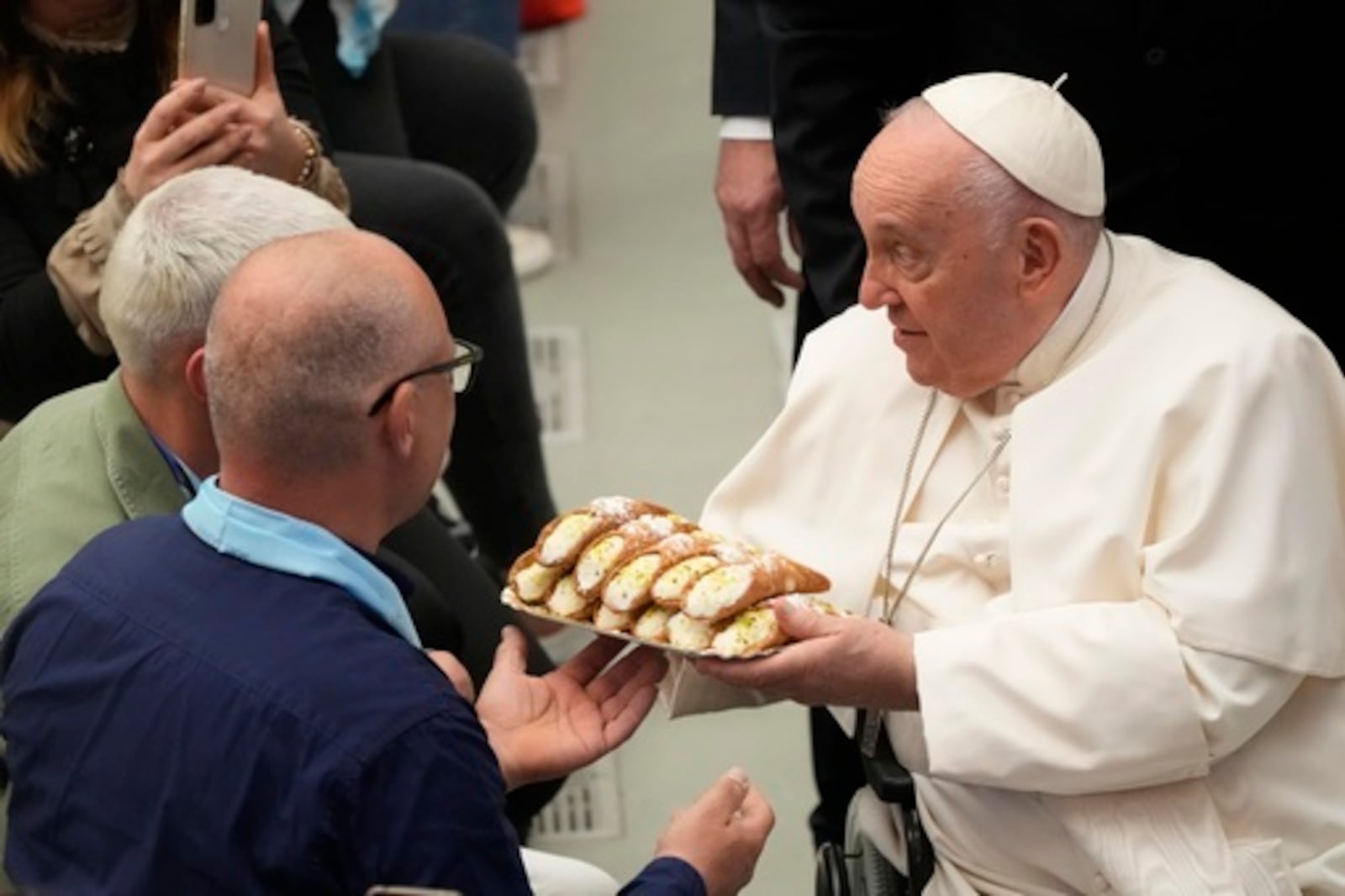 FILE - Pope Francis receives Cannoli Siciliani (traditional Sicilian pastries) as he meets with faithful of Pilgrimage of the Vocationist Family, at the Vatican, Monday, May 22, 2023. (AP Photo/Gregorio Borgia, File)