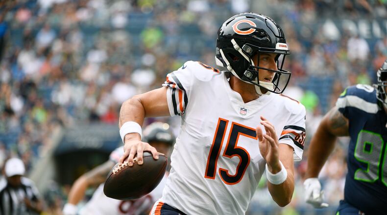 Chicago Bears quarterback Trevor Siemian (15) scrambles with the ball during the first half of a preseason NFL football game against the Seattle Seahawks, Thursday, Aug. 18, 2022, in Seattle. (AP Photo/Caean Couto)