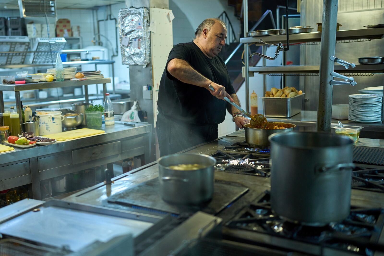 A chef cooks at Casa Pedro restaurant in Madrid, Spain, on May 16, 2025. (AP Photo/Manu Fernandez)