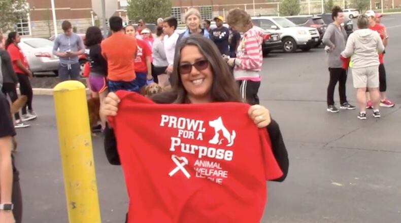 The Springfield High National Honor Society will host the Prowl for a Purpose 5K run/walk on May 7 to benefit mental health services for children at Oesterlen. Here, NHS Advisor Niki Sage holding up a shirt at a previous year's 5K. Contributed