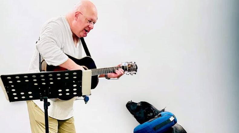 The photo is of Banjo, a resident of The Humane Society of Hobart, listening to Lee playing his guitar and singing. CONTRIBUTED